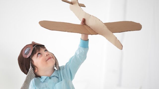 happy boy play in airplane indoors